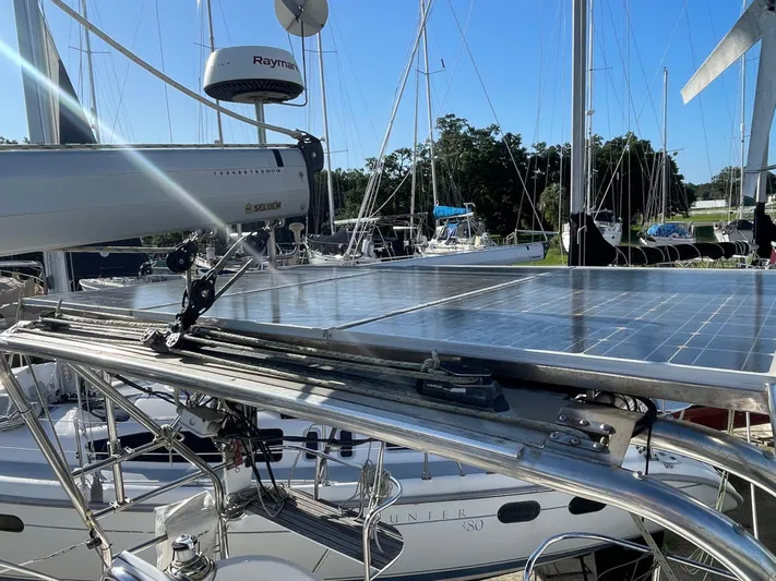 Argo Yacht Photos Pics 2004 Hunter 44 DS Deck Salon sailboat with solar panels and Raymarine equipment in marina.