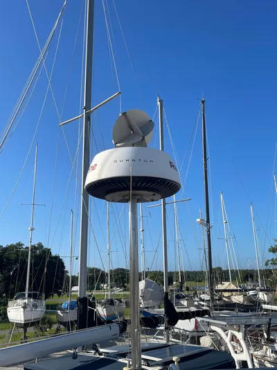 Argo Yacht Photos Pics Hunter 44 DS Deck Salon 2004 sailboat with radar, surrounded by masts under clear blue sky.