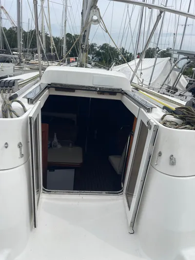 Argo Yacht Photos Pics 2004 Hunter 44 DS Deck Salon yacht with open cabin doors, docked in a marina.