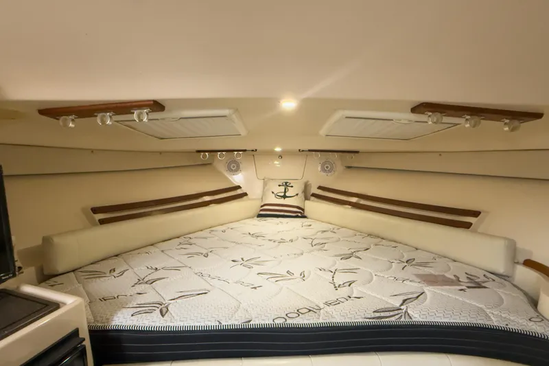  Yacht Photos Pics 2006 Grady-White Express 330 cabin interior with cozy bed and nautical decor.