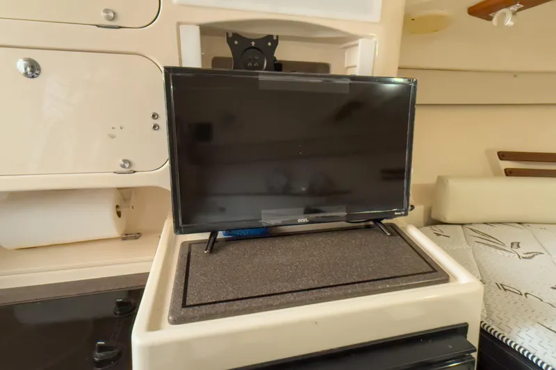  Yacht Photos Pics 2006 Grady-White Express 330 cabin interior with TV and storage compartments.