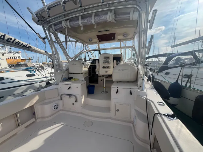  Yacht Photos Pics 2010 Grady-White Express 305 boat interior, docked at marina, showcasing seating and helm area.