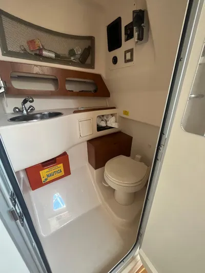  Yacht Photos Pics 2010 Grady-White Express 305 boat bathroom with sink, toilet, and storage.