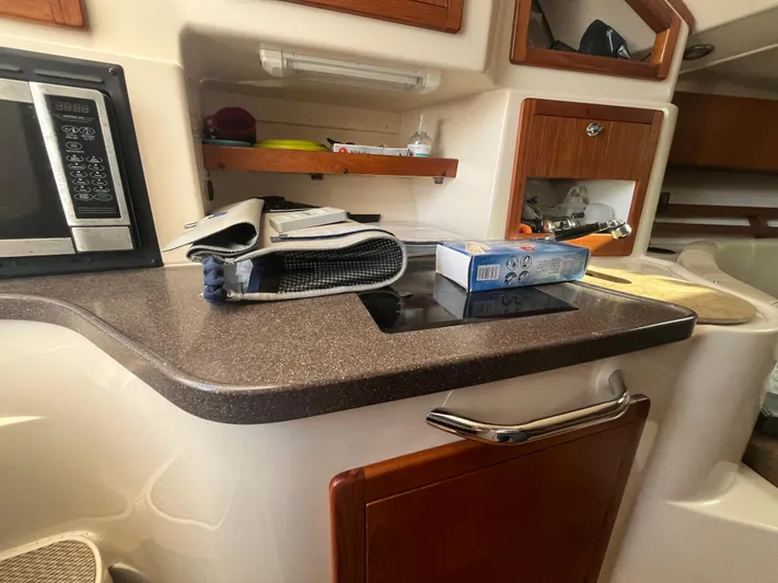  Yacht Photos Pics 2010 Grady-White Express 305 boat interior with kitchenette and storage shelves.