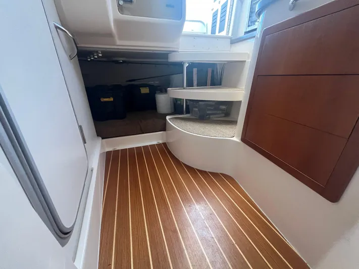  Yacht Photos Pics Interior view of 2010 Grady-White Express 305 boat, featuring wood flooring and storage compartments.