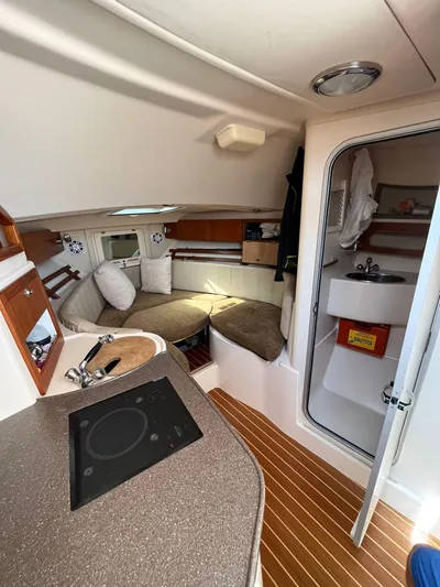  Yacht Photos Pics 2010 Grady-White Express 305 cabin interior with kitchenette and seating area.