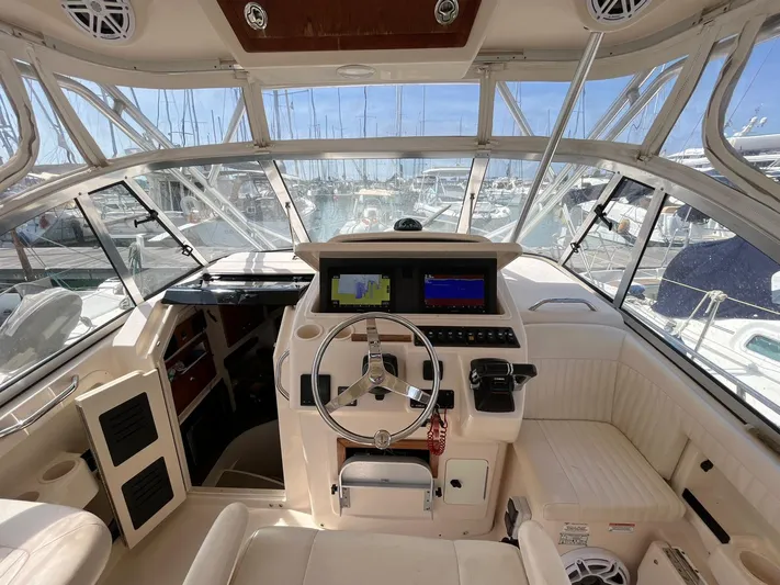  Yacht Photos Pics 2010 Grady-White Express 305 boat cockpit with steering wheel and navigation screens.