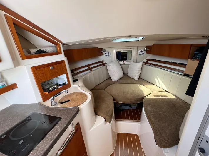  Yacht Photos Pics 2010 Grady-White Express 305 cabin interior with seating, kitchenette, and wood accents.