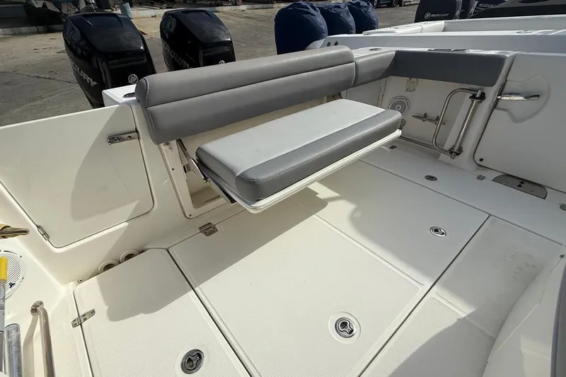  Yacht Photos Pics 2023 Boston Whaler 330 Outrage boat interior with foldable seating and Mercury engines.