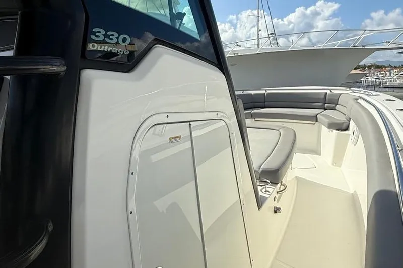  Yacht Photos Pics 2023 Boston Whaler 330 Outrage boat with spacious seating and sleek design.