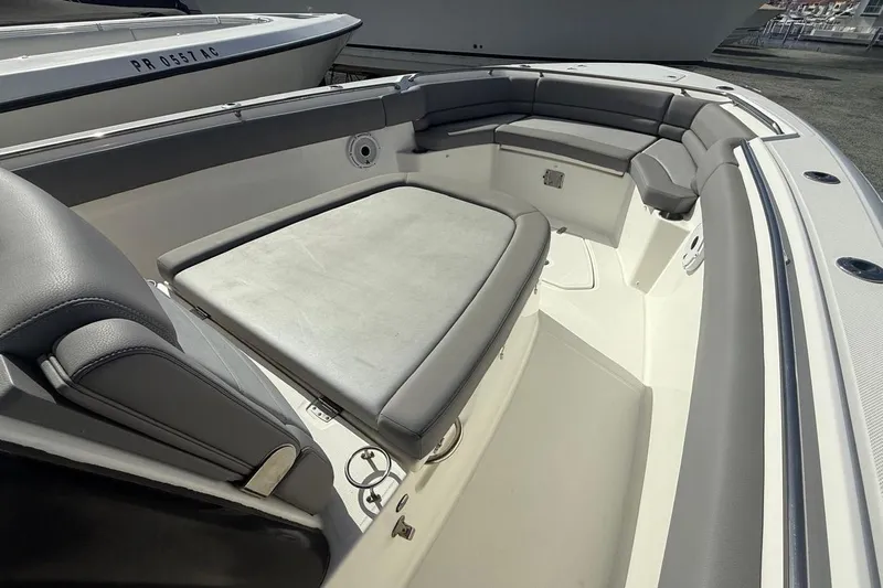  Yacht Photos Pics 2023 Boston Whaler 330 Outrage boat interior with cushioned seating and sleek design.