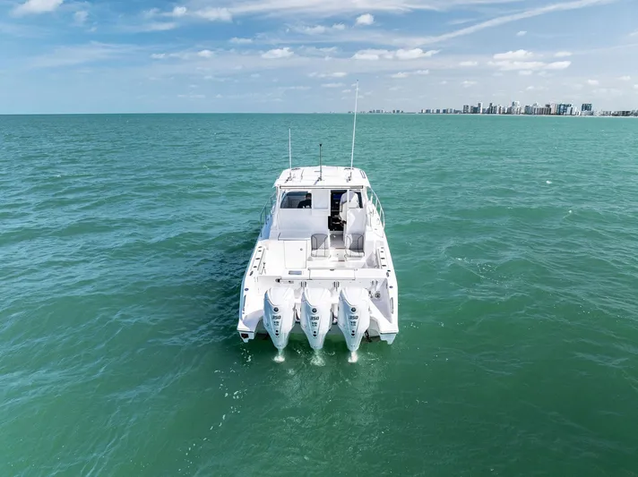 No Name Yacht Photos Pics 2025 Pursuit OS 355 Offshore boat on open sea with triple engines.