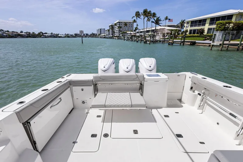 No Name Yacht Photos Pics 2025 Pursuit OS 355 Offshore boat with triple engines, docked in a scenic waterfront location.