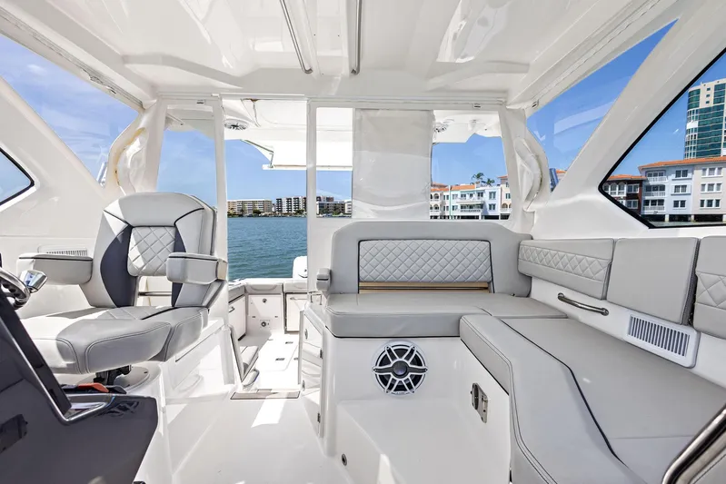No Name Yacht Photos Pics 2025 Pursuit OS 355 Offshore boat interior with luxurious seating and waterfront view.