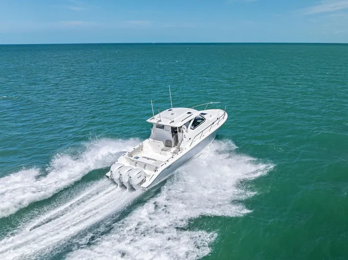 No Name Yacht Photos Pics 2025 Pursuit OS 355 Offshore cruising on open sea under clear blue sky.