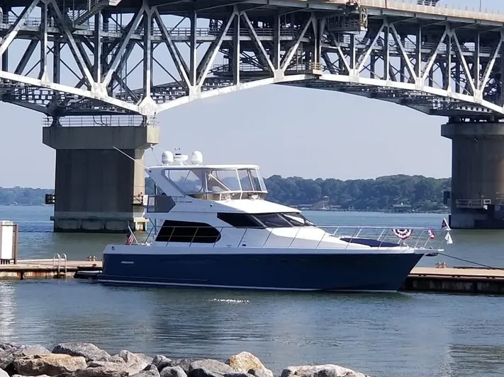 Apaiser Yacht Photos Pics Ocean Alexander 52 Sedan yacht, 2005 model, docked under a large bridge.