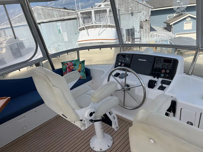 Apaiser Yacht Photos Pics Helm of 2005 Ocean Alexander 52 Sedan with steering wheel and navigation controls.