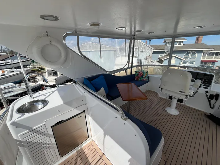 Apaiser Yacht Photos Pics 2005 Ocean Alexander 52 Sedan yacht interior with seating, table, and helm station.