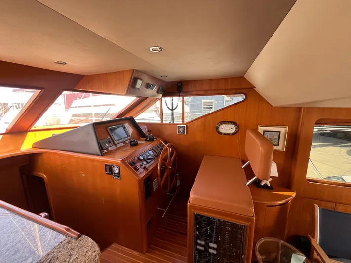 Apaiser Yacht Photos Pics 2005 Ocean Alexander 52 Sedan helm with wood finish and navigation equipment.