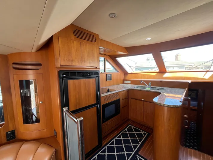 Apaiser Yacht Photos Pics Luxurious 2005 Ocean Alexander 52 Sedan yacht interior with modern kitchen and wood finishes.