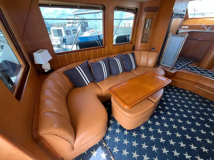 Apaiser Yacht Photos Pics Luxurious interior of 2005 Ocean Alexander 52 Sedan yacht with leather seating and nautical decor.