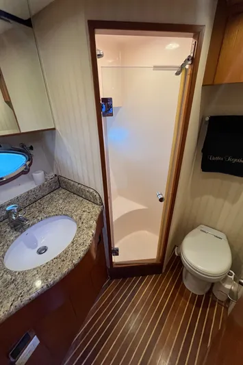 Apaiser Yacht Photos Pics 2005 Ocean Alexander 52 Sedan bathroom with granite countertop, shower, and toilet.