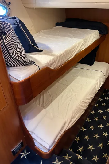 Apaiser Yacht Photos Pics Bunk beds in 2005 Ocean Alexander 52 Sedan yacht cabin with star-patterned carpet.