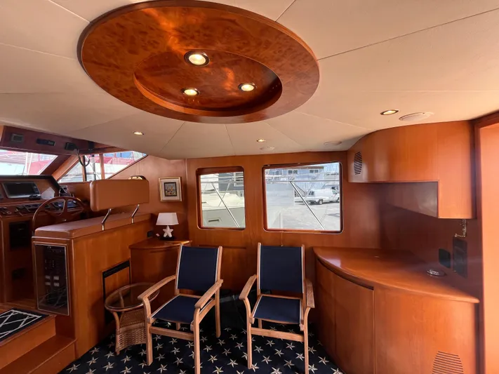 Apaiser Yacht Photos Pics Luxurious interior of 2005 Ocean Alexander 52 Sedan yacht with elegant wood finishes and seating.