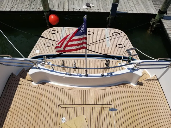 Apaiser Yacht Photos Pics 2005 Ocean Alexander 52 Sedan yacht with American flag, docked at marina.