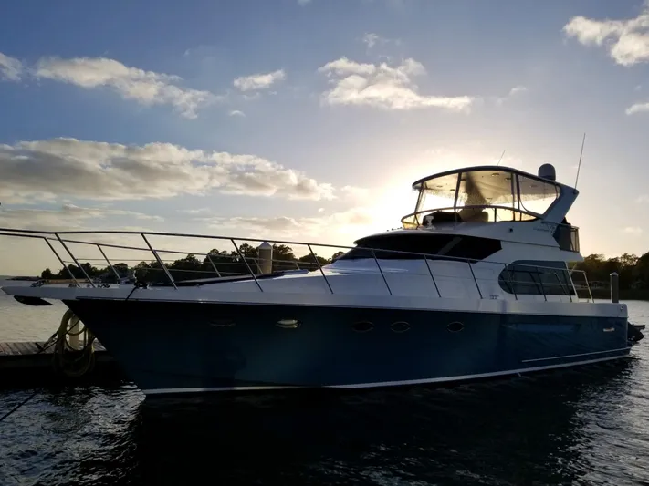 Apaiser Yacht Photos Pics 2005 Ocean Alexander 52 Sedan yacht docked at sunset, silhouetted against a vibrant sky.