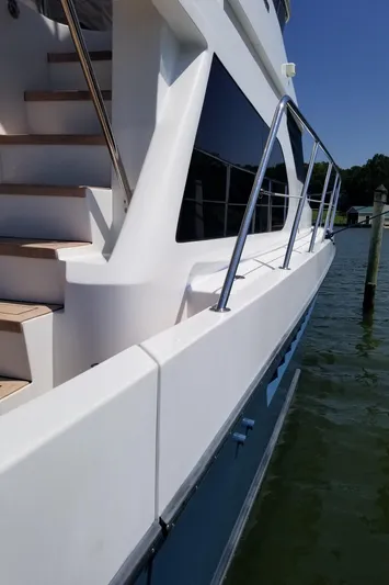 Apaiser Yacht Photos Pics 2005 Ocean Alexander 52 Sedan yacht, side view with sleek design and railing.