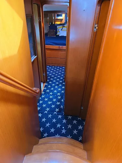 Apaiser Yacht Photos Pics Interior hallway of 2005 Ocean Alexander 52 Sedan with star-patterned carpet.