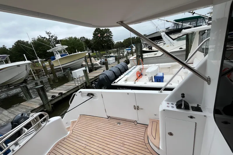 Apaiser Yacht Photos Pics 2005 Ocean Alexander 52 Sedan yacht docked at marina with wooden deck and nearby boats.