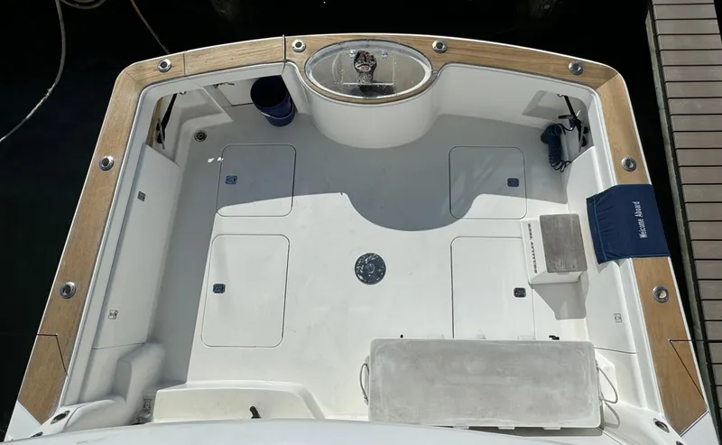  Yacht Photos Pics 2005 Ocean Yachts 46 Super Sport boat deck with wooden trim and fishing equipment.