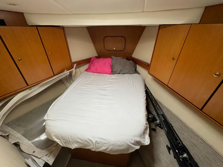  Yacht Photos Pics Interior cabin of 2005 Ocean Yachts 46 Super Sport with bed and wooden cabinets.