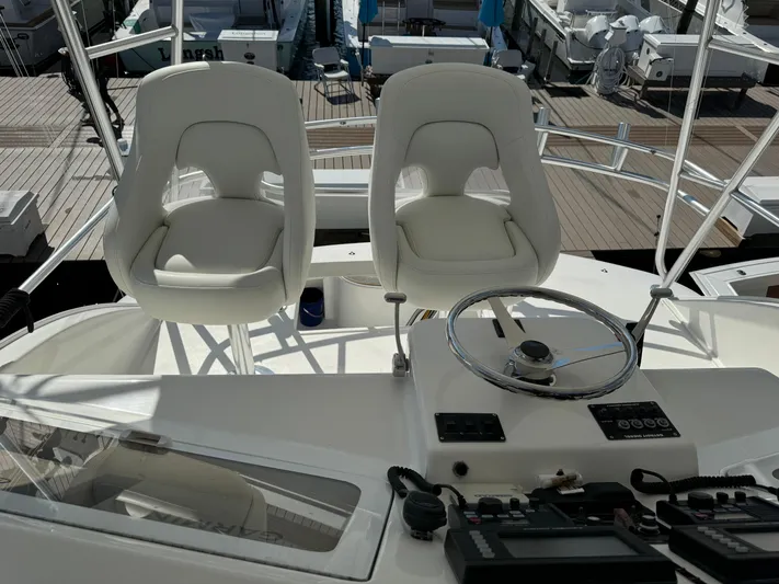  Yacht Photos Pics 2005 Ocean Yachts 46 Super Sport helm with white captain chairs and control panel.
