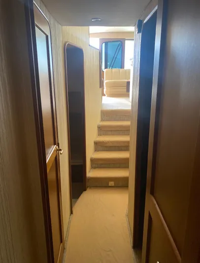  Yacht Photos Pics Interior hallway of 2005 Ocean Yachts 46 Super Sport with wooden paneling and stairs.