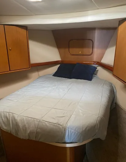  Yacht Photos Pics Cozy bedroom in 2005 Ocean Yachts 46 Super Sport with wood cabinets and bedding.
