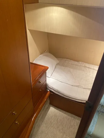  Yacht Photos Pics Cozy cabin interior of 2005 Ocean Yachts 46 Super Sport with bed and wooden cabinetry.