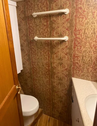  Yacht Photos Pics Bathroom interior of 2005 Ocean Yachts 46 Super Sport with patterned wallpaper and wooden accents.