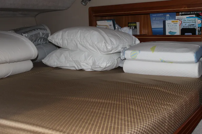  Yacht Photos Pics Cozy cabin bed with pillows and books, Aspen B100, 2016 model.