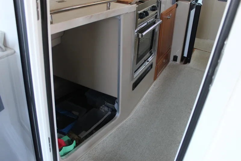 Yacht Photos Pics Compact kitchen area in 2016 Aspen B100 boat with oven and storage.