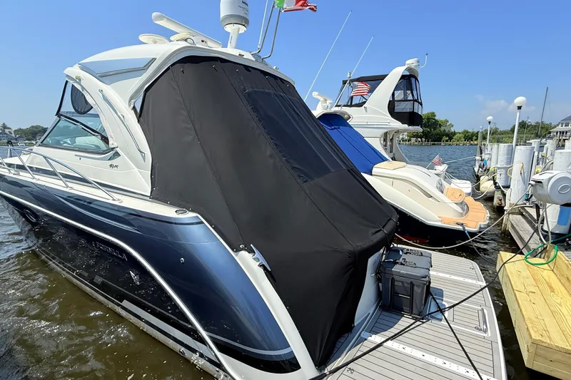  Yacht Photos Pics 2022 Formula 40 Performance Cruiser docked at marina, covered with black tarp.
