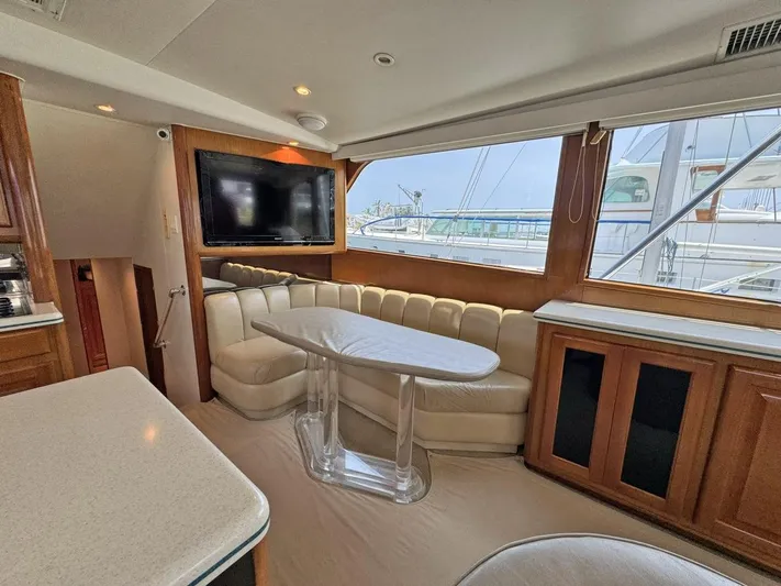  Yacht Photos Pics Interior of 1998 Viking 58 Convertible yacht with leather seating and large windows.