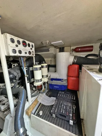  Yacht Photos Pics Engine room of a 1998 Viking 58 Convertible yacht with tools and equipment.