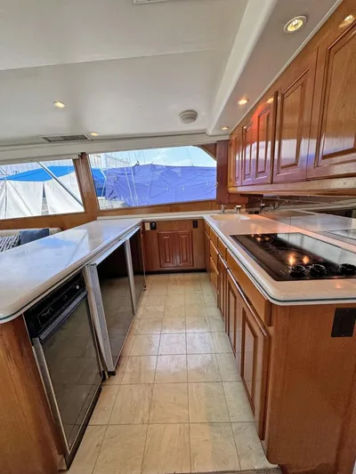  Yacht Photos Pics Spacious kitchen area in a 1998 Viking 58 Convertible yacht with wooden cabinets and modern appliances.