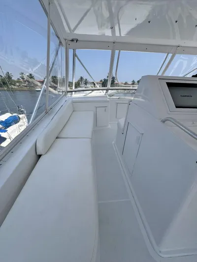  Yacht Photos Pics 1998 Viking 58 Convertible yacht interior with white seating and navigation console.