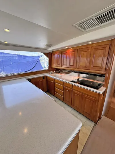  Yacht Photos Pics 1998 Viking 58 Convertible yacht kitchen with wooden cabinets and modern appliances.
