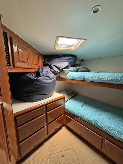  Yacht Photos Pics 1998 Viking 58 Convertible cabin with bunk beds and wooden storage cabinets.