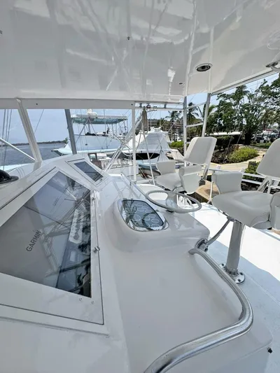  Yacht Photos Pics 1998 Viking 58 Convertible yacht helm station with white seating and navigation equipment.